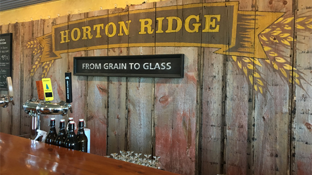 The Horton Ridge logo adorns the wall and beer bottles line the bar.